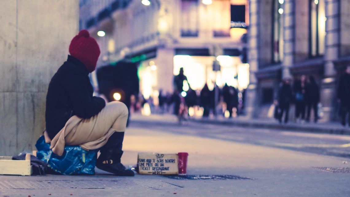 Homeless person sitting on the street